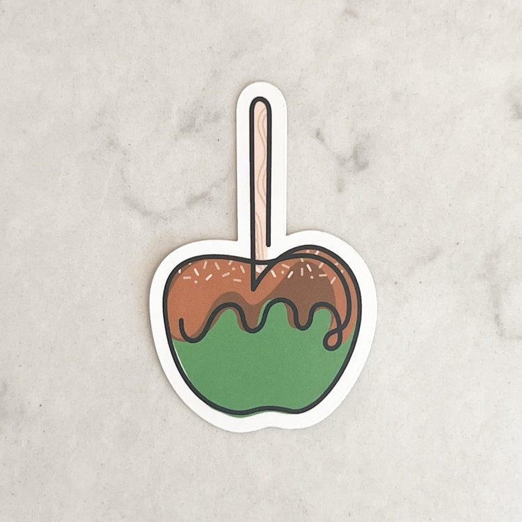 Sticker of a caramel apple on a marble surface
