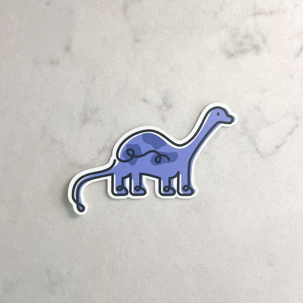Sticker of a blue dinosaur on a marble surface