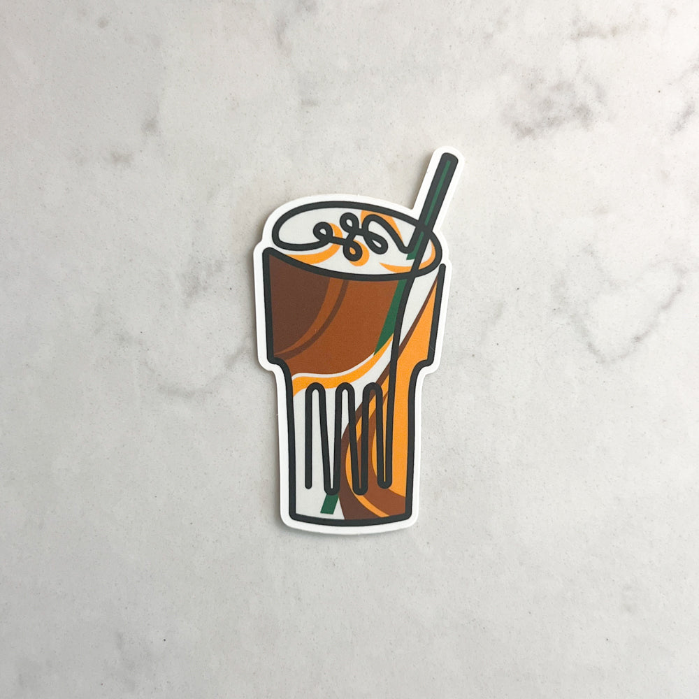 Sticker of a coffee drink with a straw on a marble surface