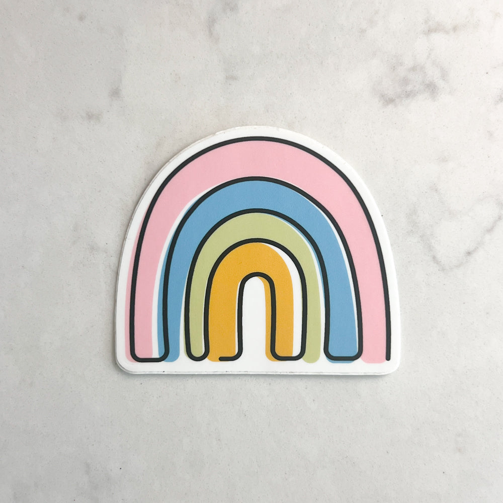 Colorful rainbow-shaped sticker on a light gray background