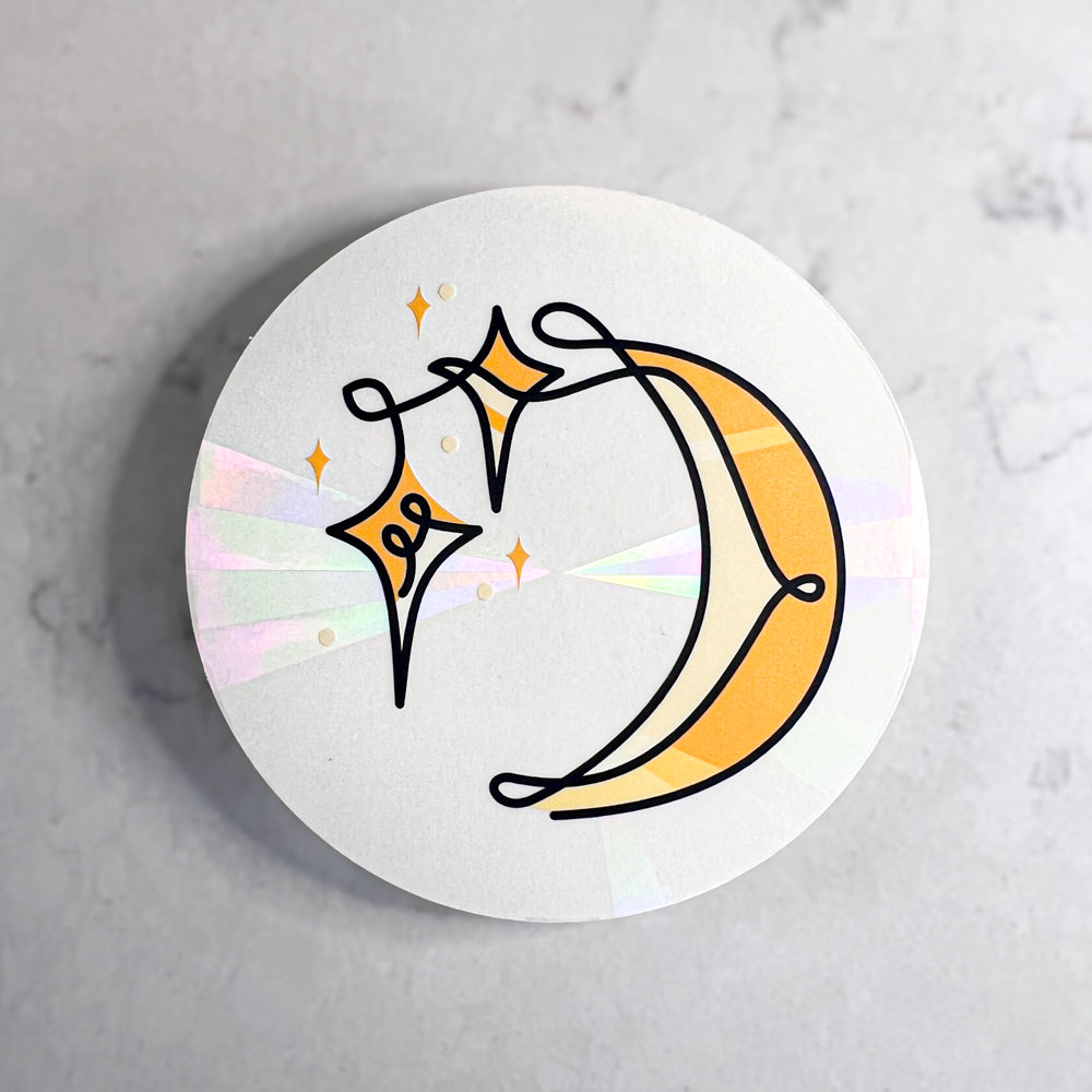 Rainbow suncatcher sticker with stars and moon
design on a gray background