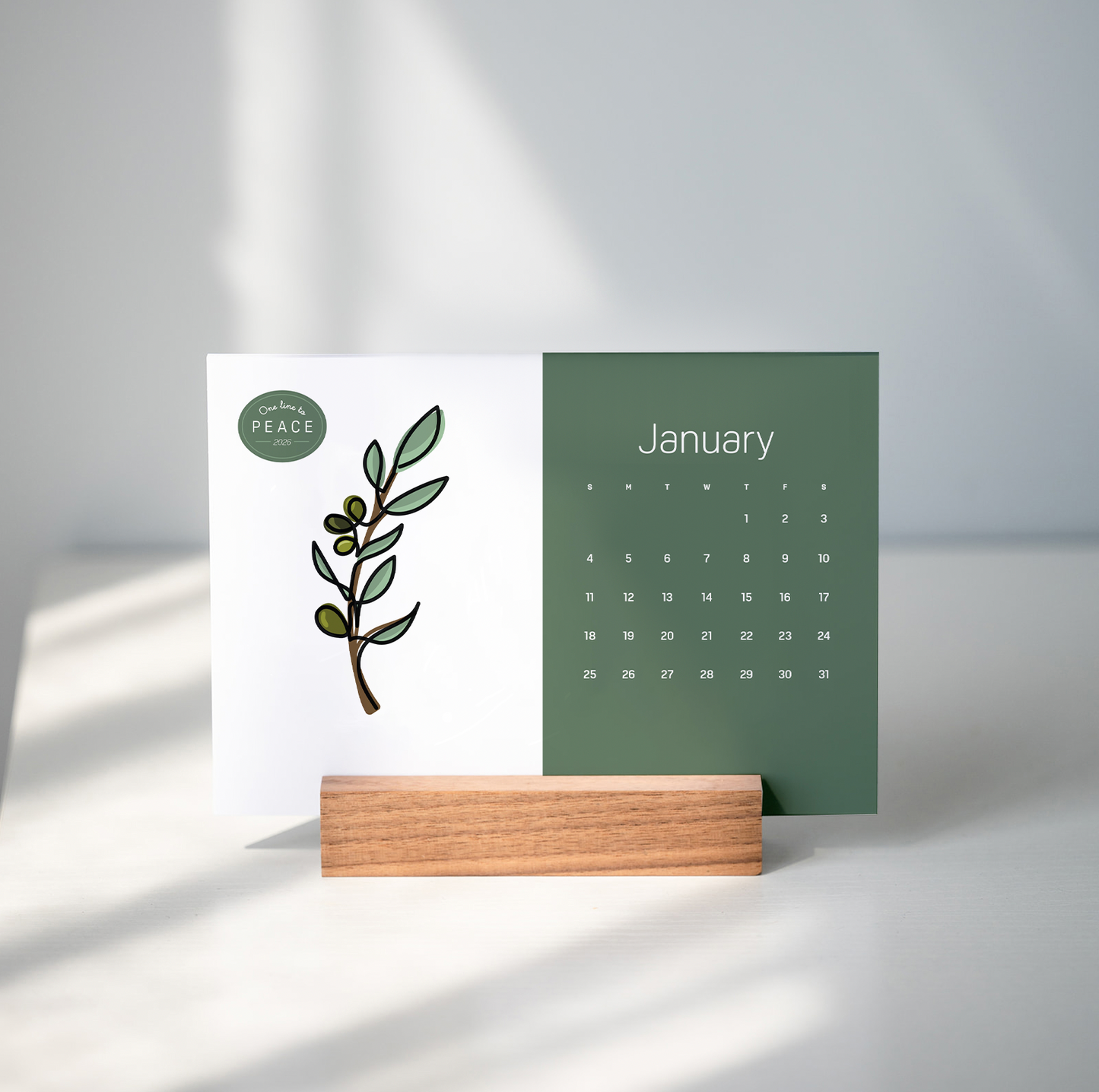 paper desk calendar in wooden base on gray bcakground