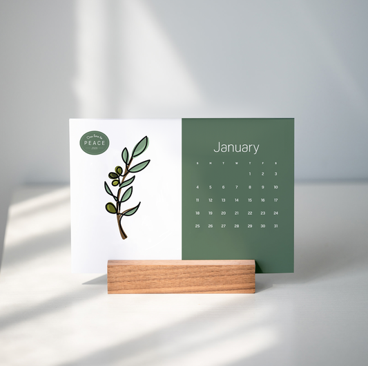 paper desk calendar in wooden base on gray bcakground