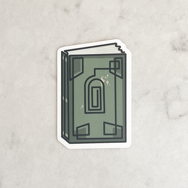 Sticker of a green book with an arch design on a marble background
