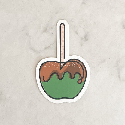 Sticker of a caramel apple on a marble surface