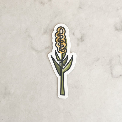 Sticker of a corn cob on a marble surface