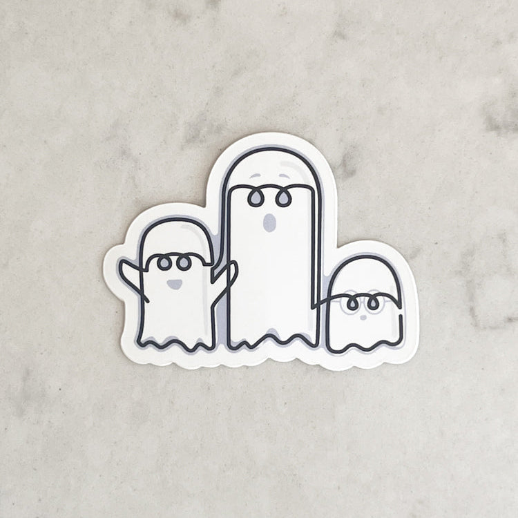 Sticker of three cartoon ghosts on a marble background