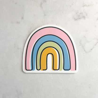 Colorful rainbow-shaped sticker on a light gray background